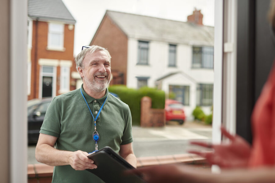 local housing officer calls on tenant holding a clipboard